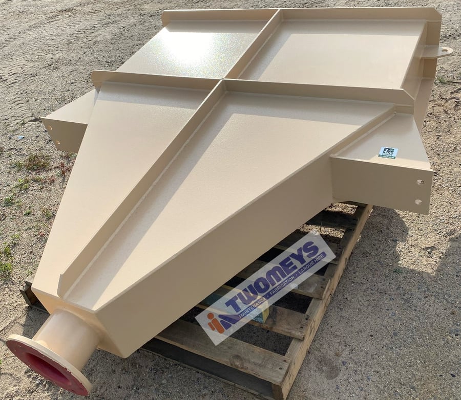 Cream painted fabricated splitter chute with a flanged outlet, on a pallet in the yard