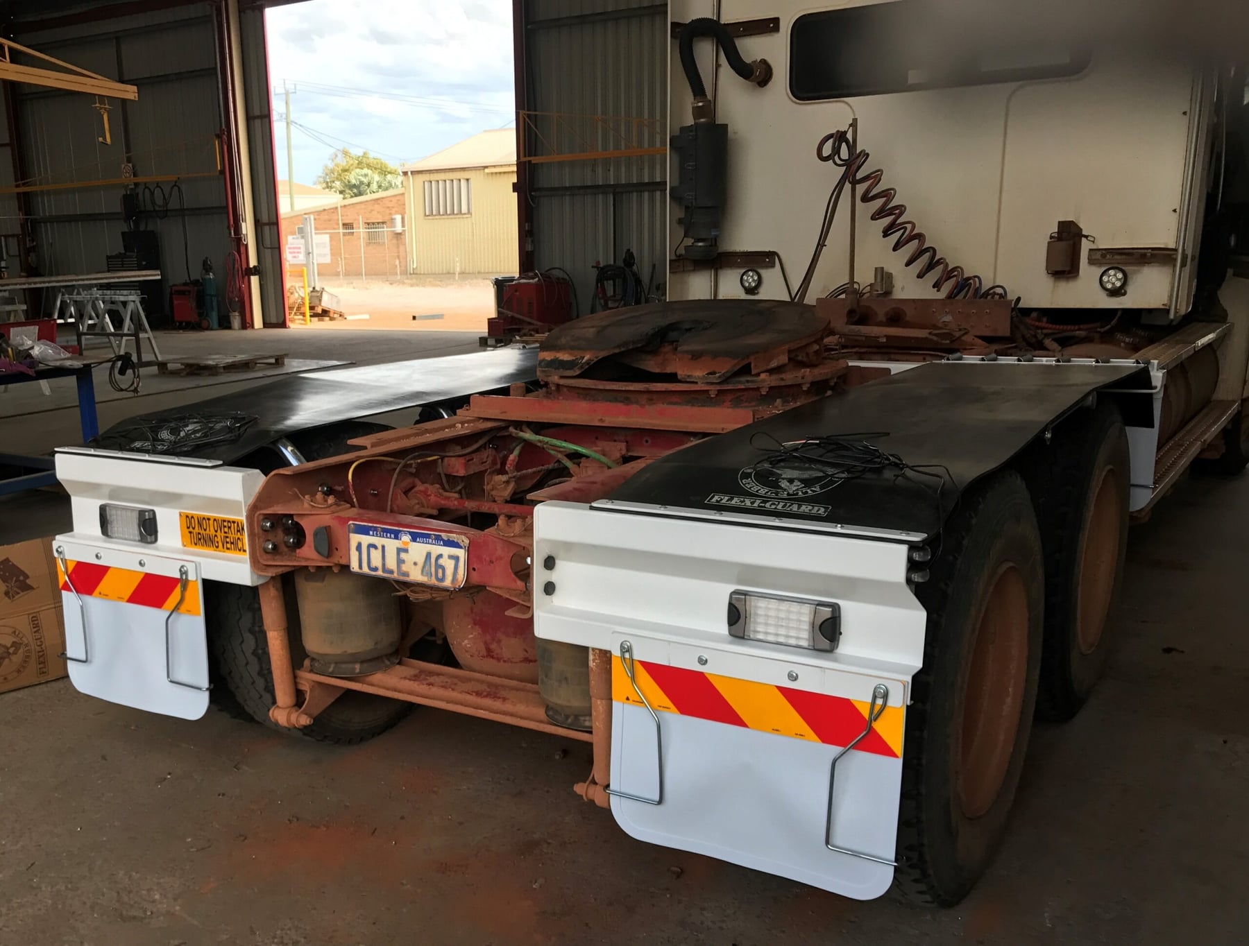 Prime mover fitted with new mudguards and spray flaps inside the Twomeys workshop